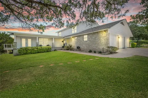 a front view of house with yard and green space