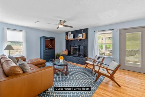 a living room with furniture a fireplace and a window