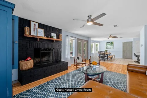 a living room with furniture a rug and a fireplace
