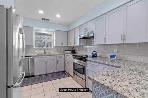 a kitchen with a white stove top oven and cabinets