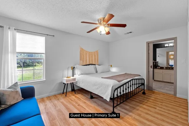 a bedroom with a bed and wooden floor