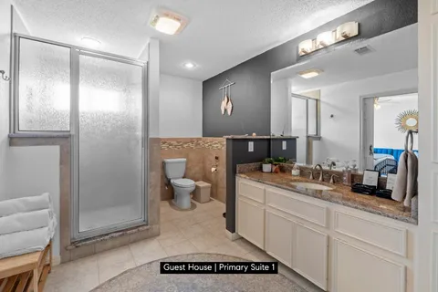 a spacious bathroom with a shower a sink and a mirror