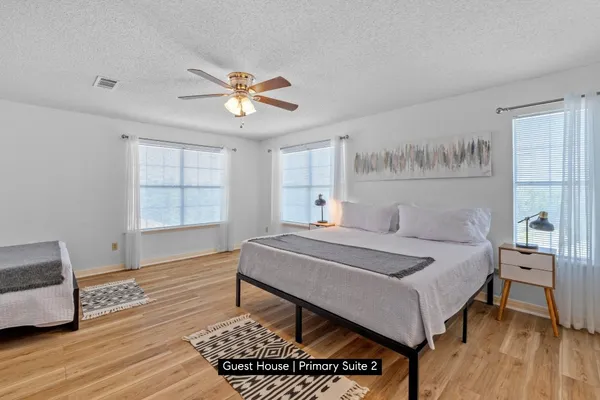 a spacious bedroom with a bed and a window