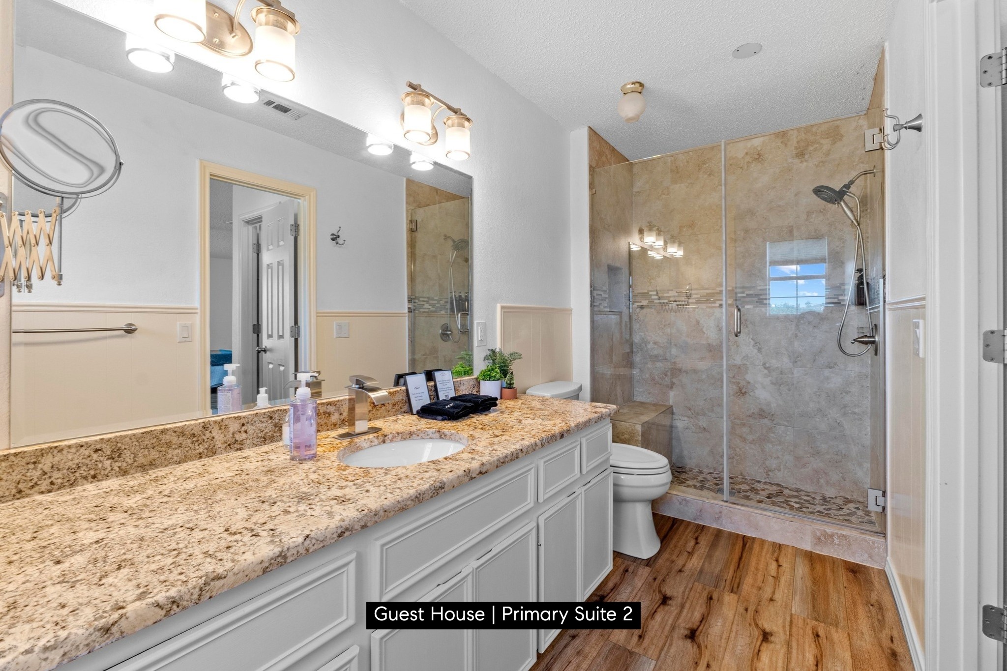 11104 Trails End Road Leander, TX 78641 - Photo 31 of 40 a bathroom with a granite countertop sink a toilet a mirror and shower
