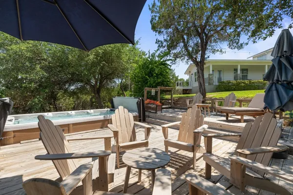 a view of a patio with table and chairs under an umbrella