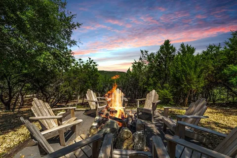 a view of a patio with table and chairs and potted plants