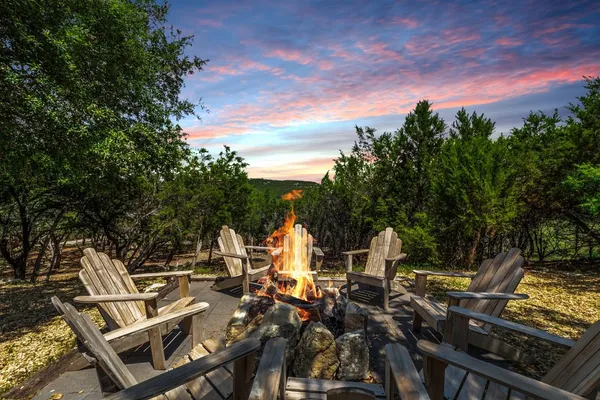 a view of a patio with table and chairs and potted plants