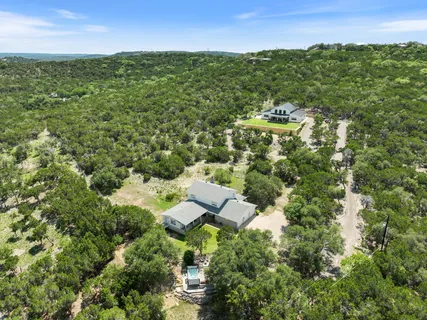 an aerial view of residential houses with outdoor and green space