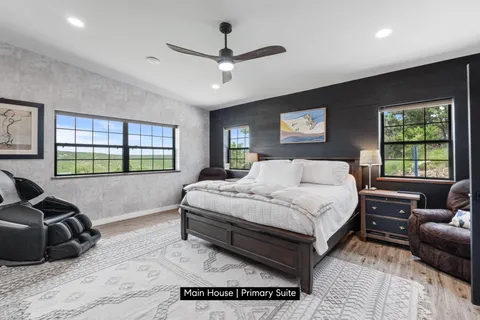 a spacious bedroom with a bed window and couch