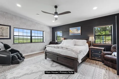 a spacious bedroom with a bed window and couch