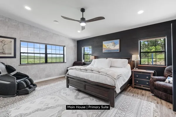 a spacious bedroom with a bed window and couch