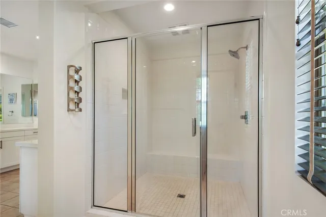 a bathroom with a shower and a glass door