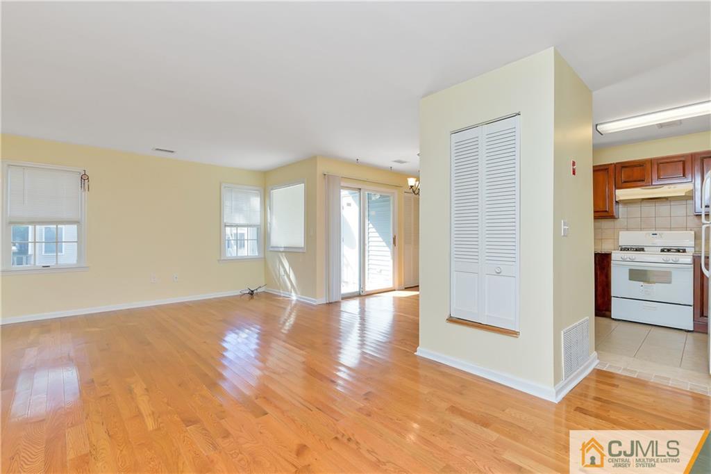 810 Edpas Road, Unit 810 New Brunswick, NJ 08901 - Photo 2 of 15 a view of an empty room with window and wooden floor
