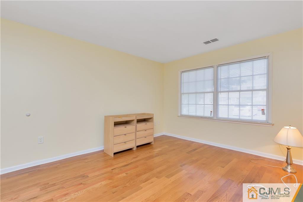 810 Edpas Road, Unit 810 New Brunswick, NJ 08901 - Photo 11 of 15 a view of an empty room with a window and dresser