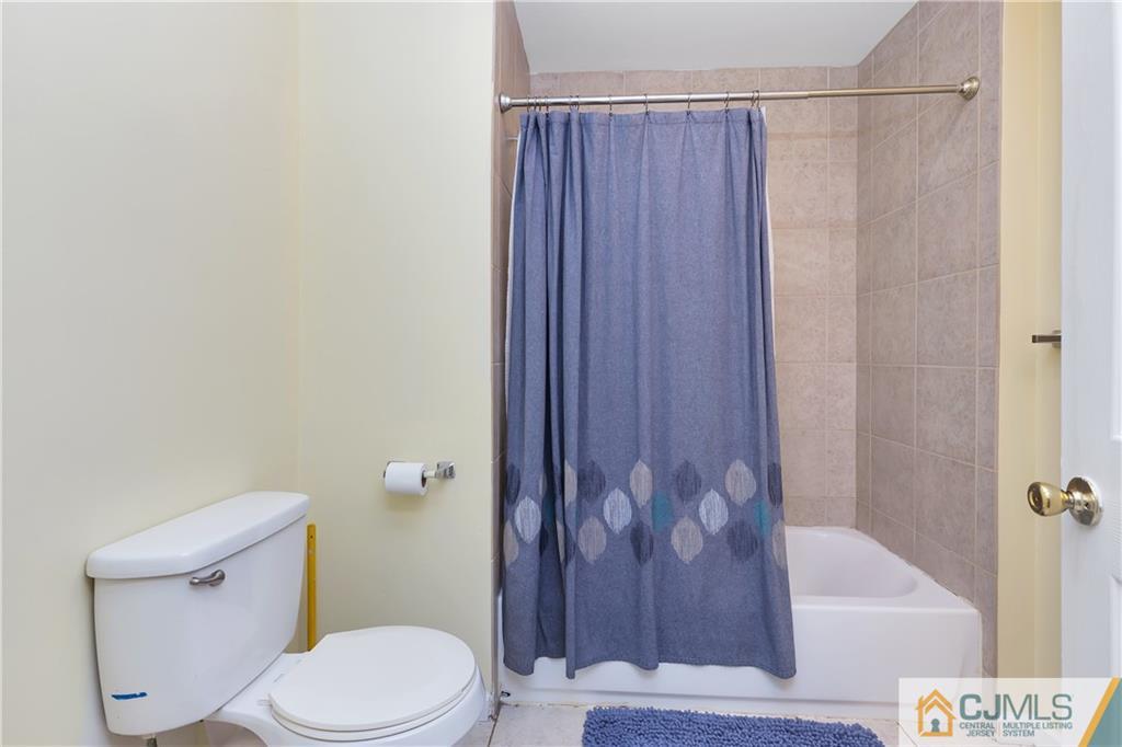 810 Edpas Road, Unit 810 New Brunswick, NJ 08901 - Photo 13 of 15 a white toilet sitting next to a bath tub