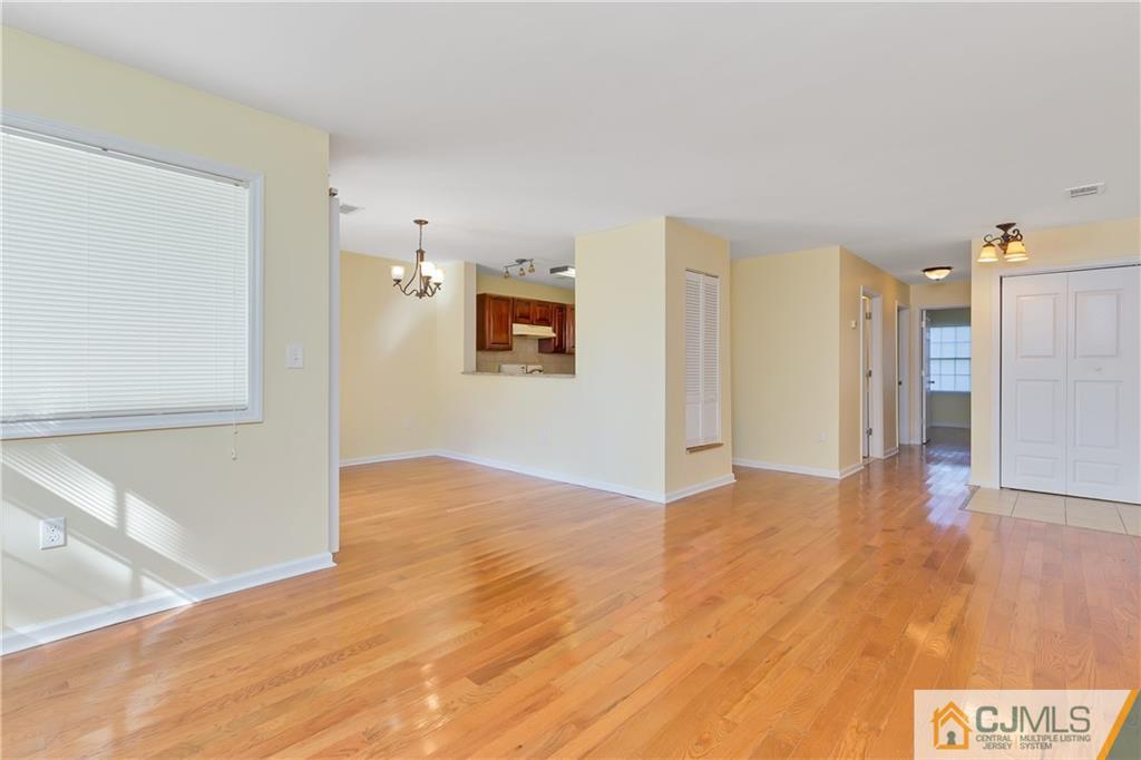810 Edpas Road, Unit 810 New Brunswick, NJ 08901 - Photo 4 of 15 a view of a big room with wooden floor and windows