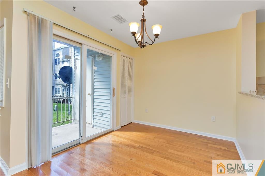 810 Edpas Road, Unit 810 New Brunswick, NJ 08901 - Photo 6 of 15 a view of empty room with wooden floor and fan