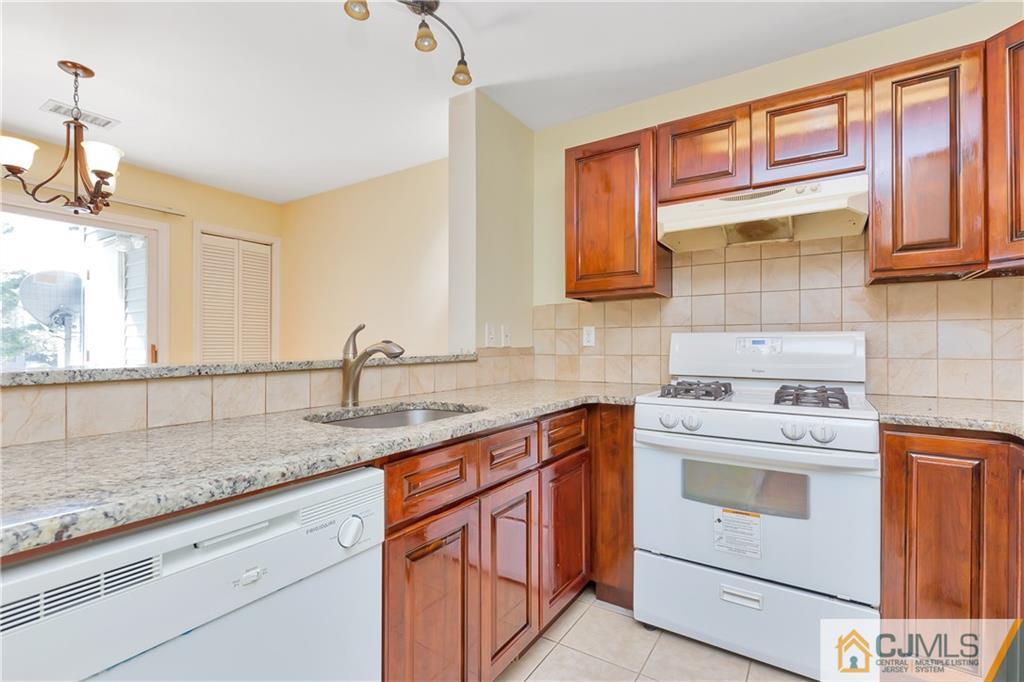 810 Edpas Road, Unit 810 New Brunswick, NJ 08901 - Photo 8 of 15 a kitchen with granite countertop cabinets stainless steel appliances and a sink