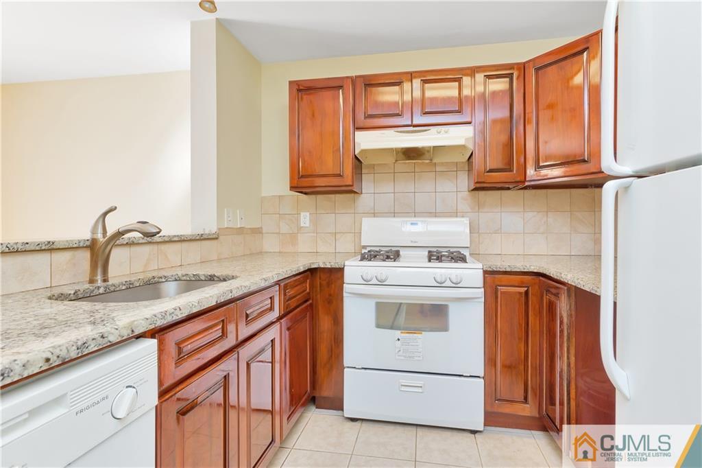 810 Edpas Road, Unit 810 New Brunswick, NJ 08901 - Photo 9 of 15 a kitchen with granite countertop a sink stainless steel appliances and cabinets