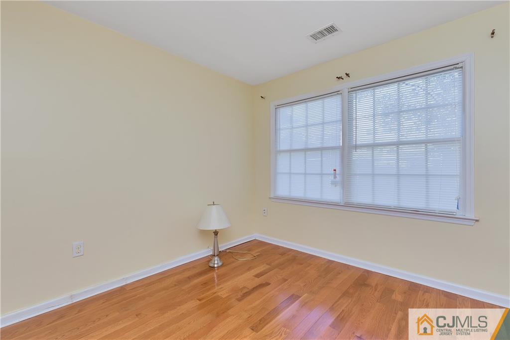 810 Edpas Road, Unit 810 New Brunswick, NJ 08901 - Photo 10 of 15 a view of an empty room with a window and wooden floor
