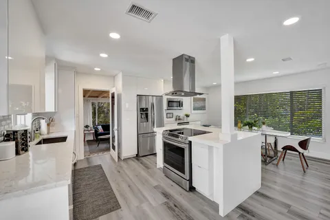 a kitchen with stainless steel appliances kitchen island a large island in the center