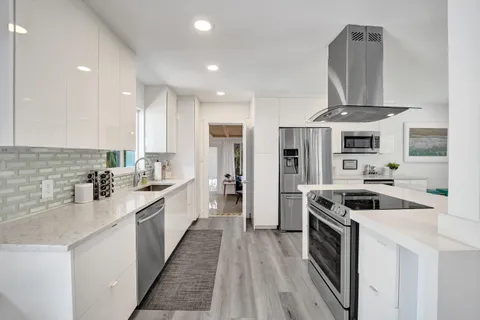 a kitchen with stainless steel appliances granite countertop a stove and a sink