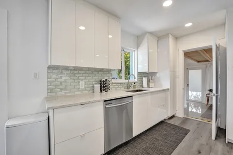 a kitchen with a sink cabinets and window