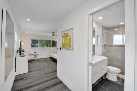 a bathroom with a toilet sink a shower and a mirror