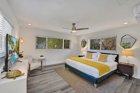 a bedroom with a bed and wooden floor