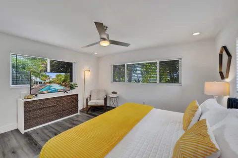a bedroom with a bed and a flat screen tv