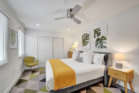 a bedroom with a bed and a window