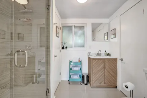 a bathroom with a tub sink and mirror