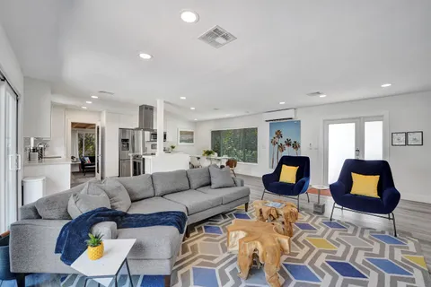 a living room with furniture and kitchen view