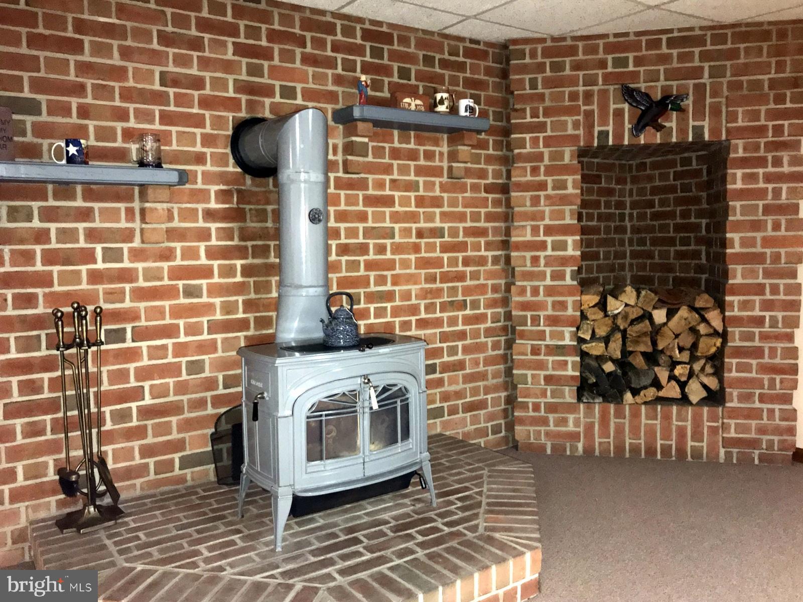 2712 Garrett Road White Hall, MD 21161 - Photo 25 of 48 Wood stove with firewood neiche
