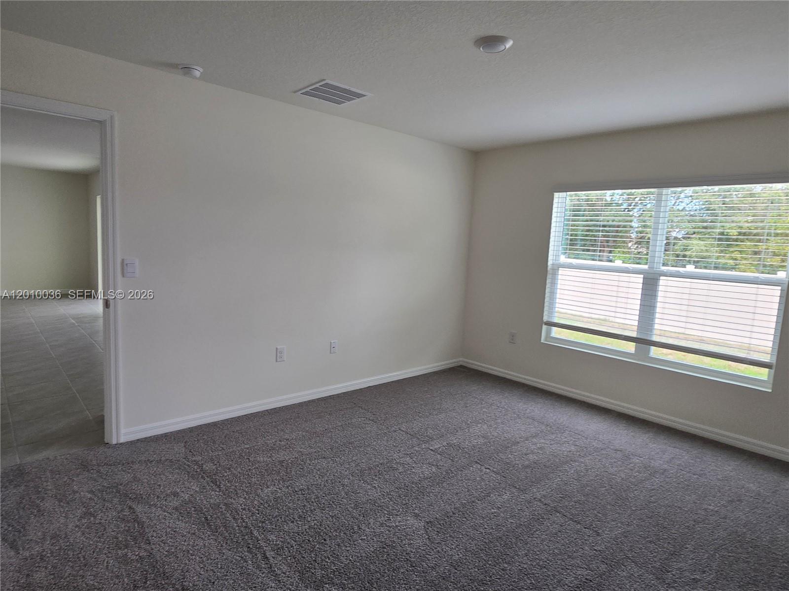 9871 Southeast 161st Lane Road Summerfield, FL 34491 - Photo 20 of 31 an empty room with windows