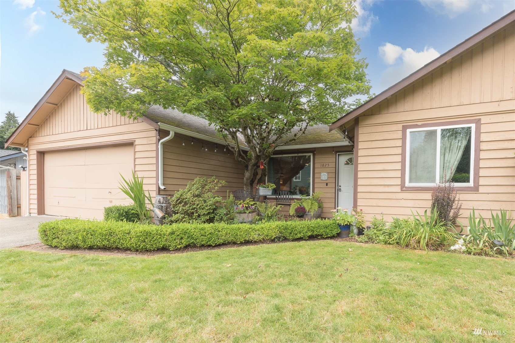 a front view of a house with garden