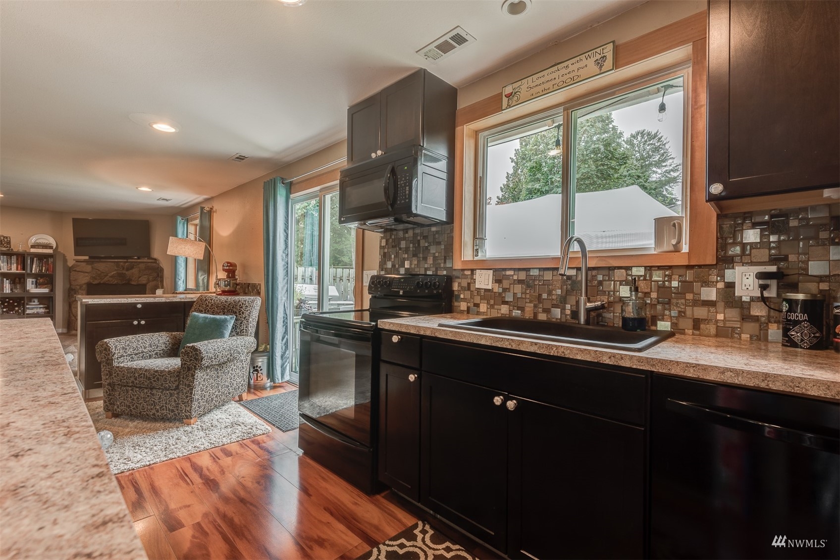 1825 225th Street Southeast Bothell, WA 98021 - Photo 15 of 30 a kitchen with stainless steel appliances granite countertop sink stove and large window
