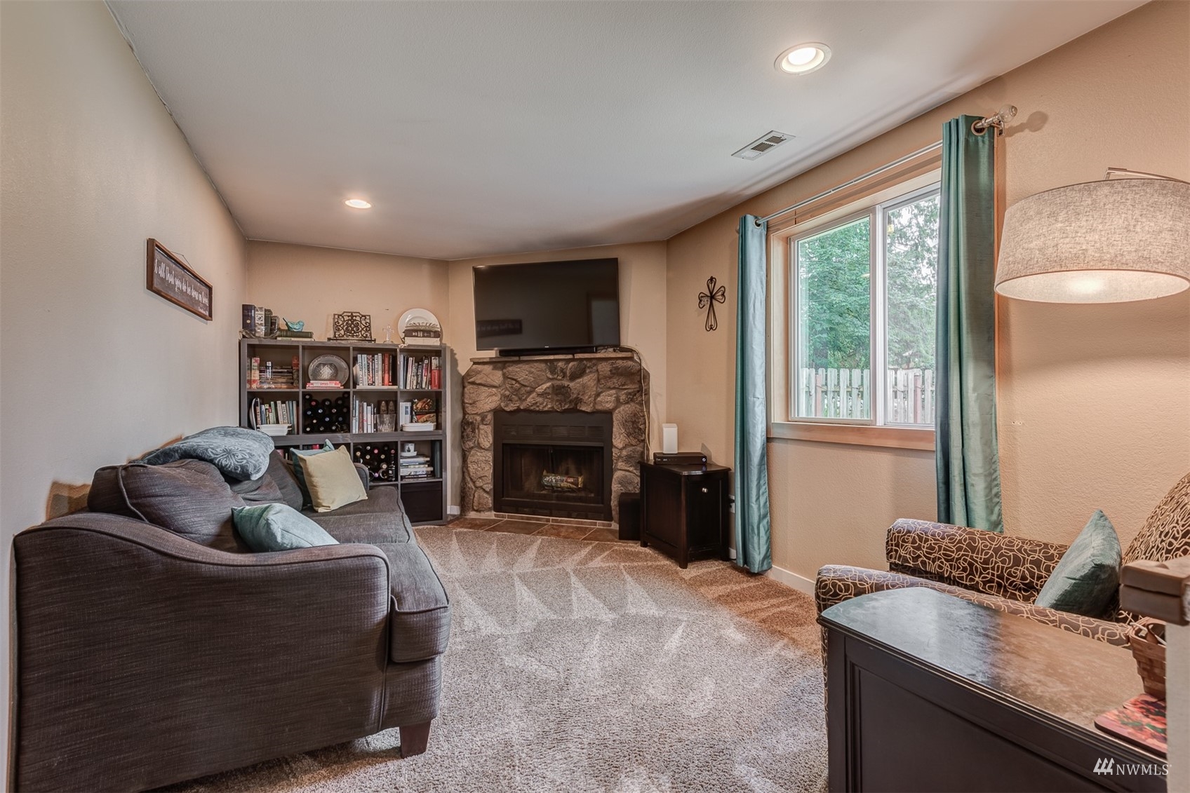 1825 225th Street Southeast Bothell, WA 98021 - Photo 17 of 30 a living room with furniture a large window and a fireplace