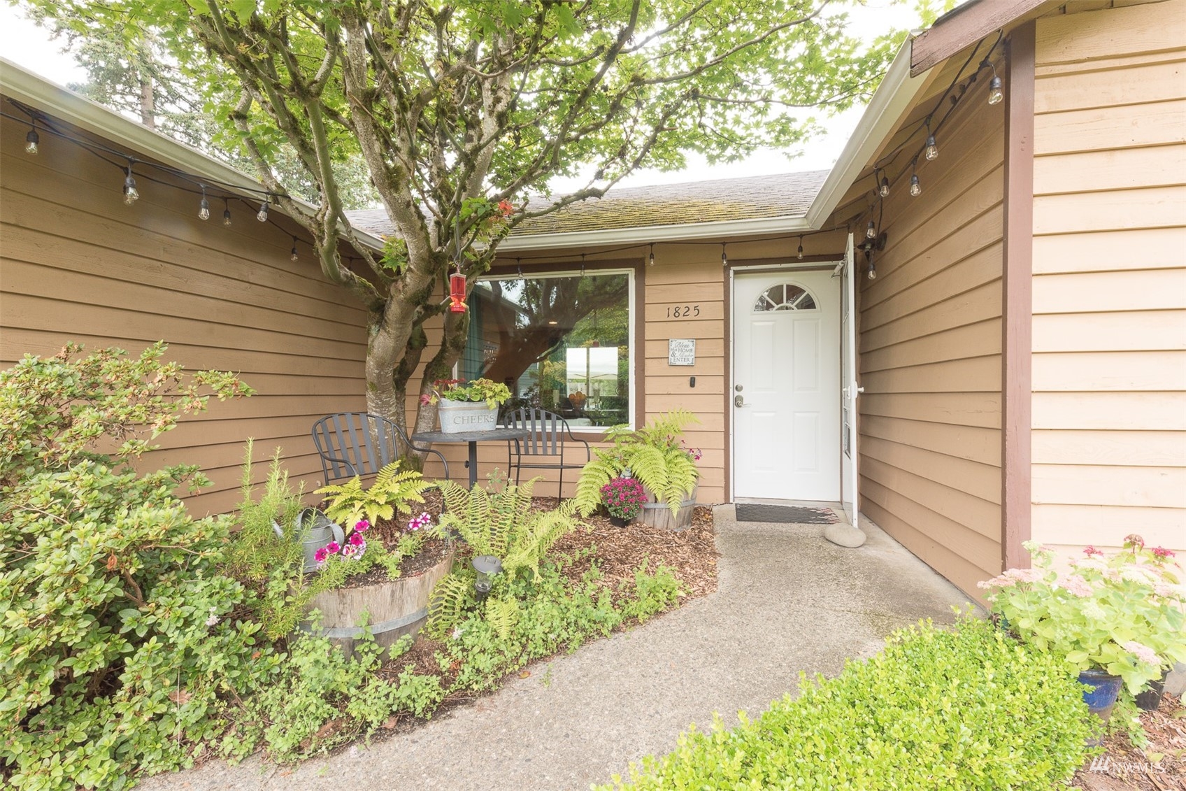 1825 225th Street Southeast Bothell, WA 98021 - Photo 5 of 30 a front view of a house with a garden
