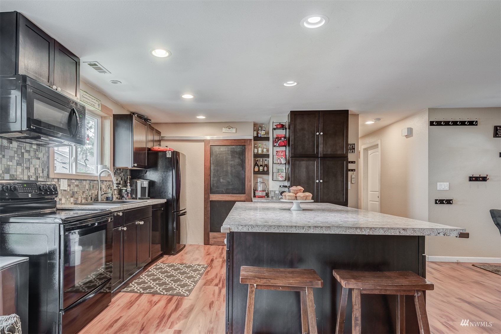 1825 225th Street Southeast Bothell, WA 98021 - Photo 10 of 30 a kitchen with refrigerator cabinets and wooden floor
