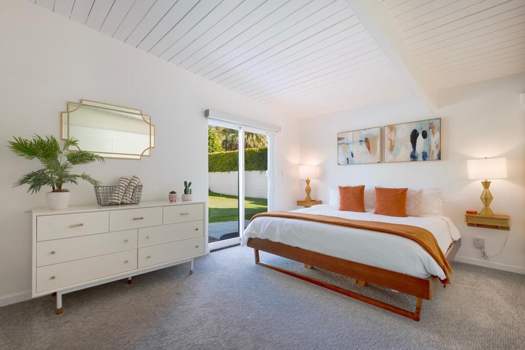 302 East Racquet Club Road Palm Springs, CA 92262 - Photo 16 of 38 a spacious bedroom with a bed and window