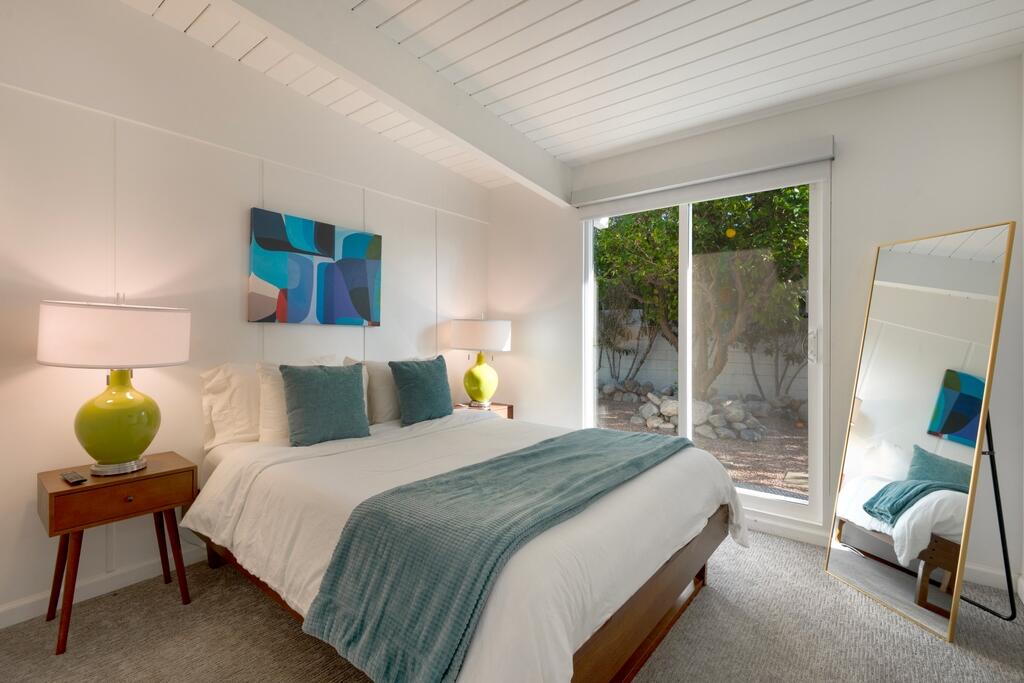 302 East Racquet Club Road Palm Springs, CA 92262 - Photo 19 of 38 a bedroom with a bed chair and window