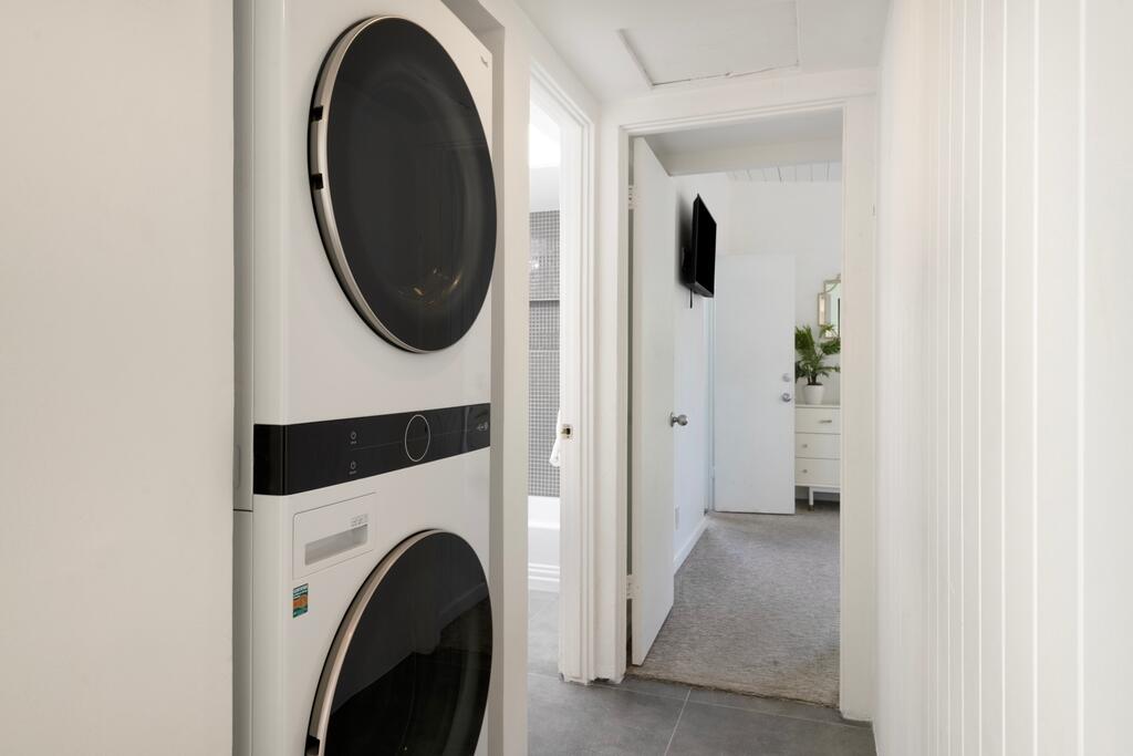 302 East Racquet Club Road Palm Springs, CA 92262 - Photo 22 of 38 a view of a hallway with washer and dryer