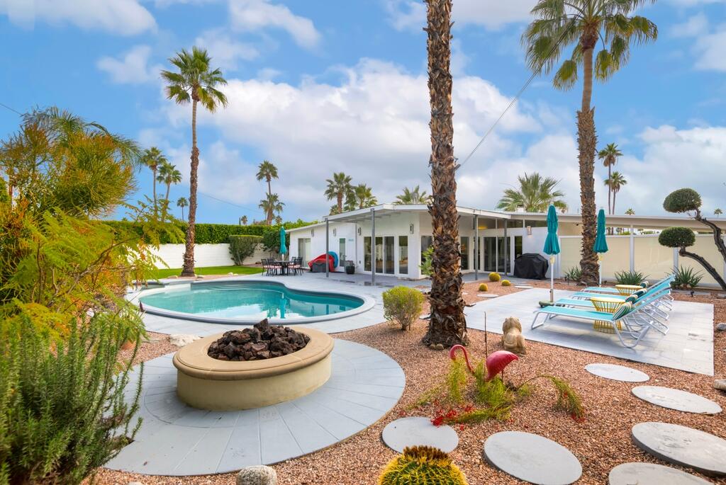 302 East Racquet Club Road Palm Springs, CA 92262 - Photo 3 of 38 a view of a swimming pool with a patio and dining table