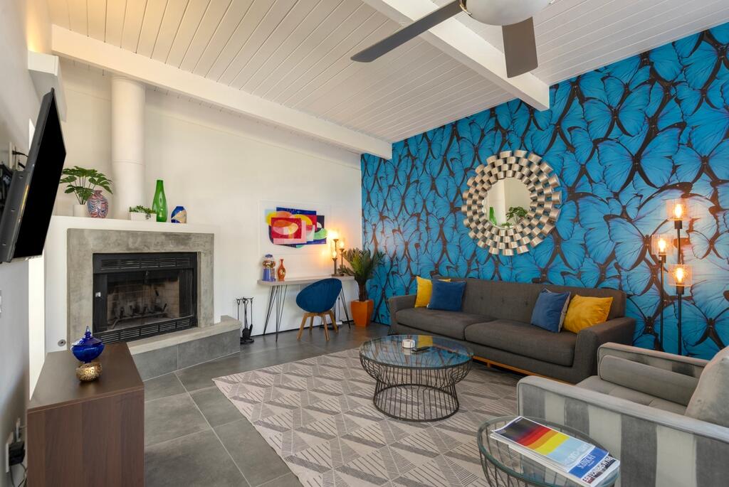 302 East Racquet Club Road Palm Springs, CA 92262 - Photo 5 of 38 a living room with furniture and a fireplace