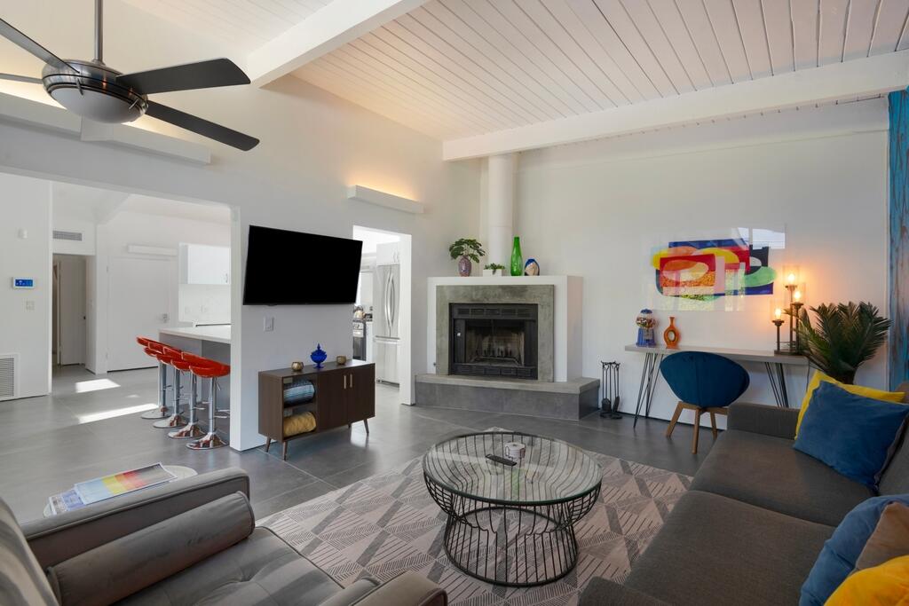 302 East Racquet Club Road Palm Springs, CA 92262 - Photo 6 of 38 a living room with furniture and a flat screen tv