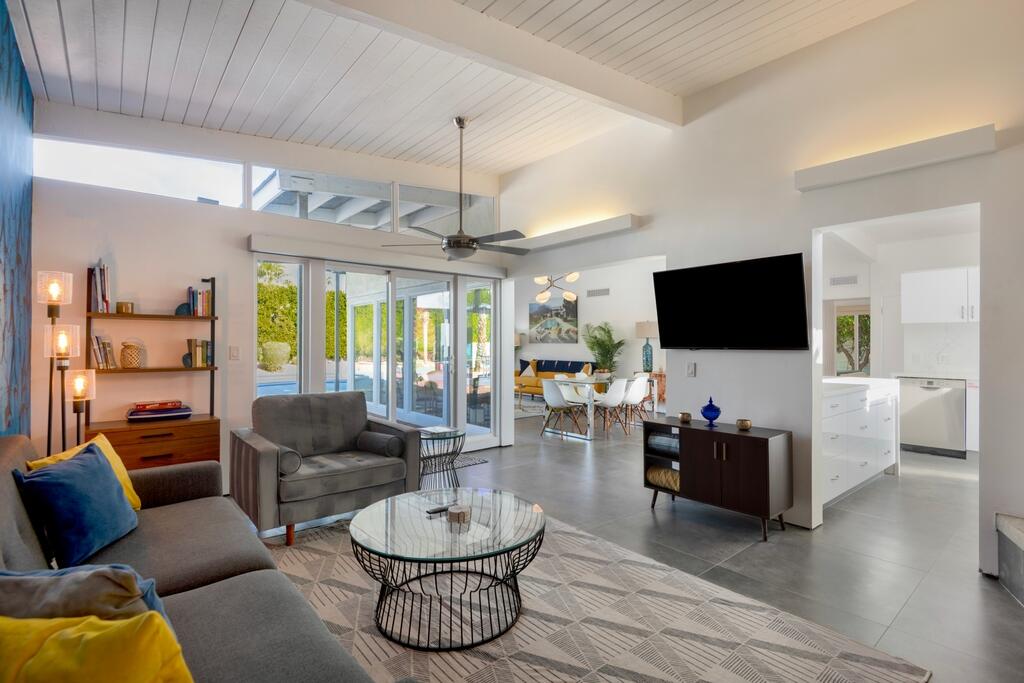 302 East Racquet Club Road Palm Springs, CA 92262 - Photo 7 of 38 a living room with furniture and a flat screen tv