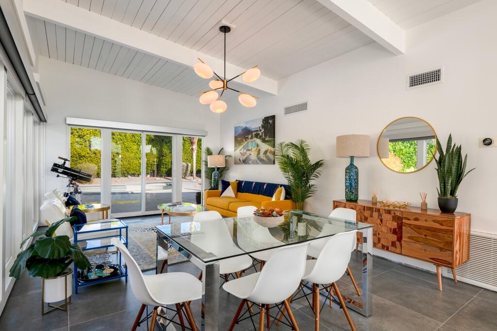 302 East Racquet Club Road Palm Springs, CA 92262 - Photo 8 of 38 a dining room with furniture a window and a chandelier