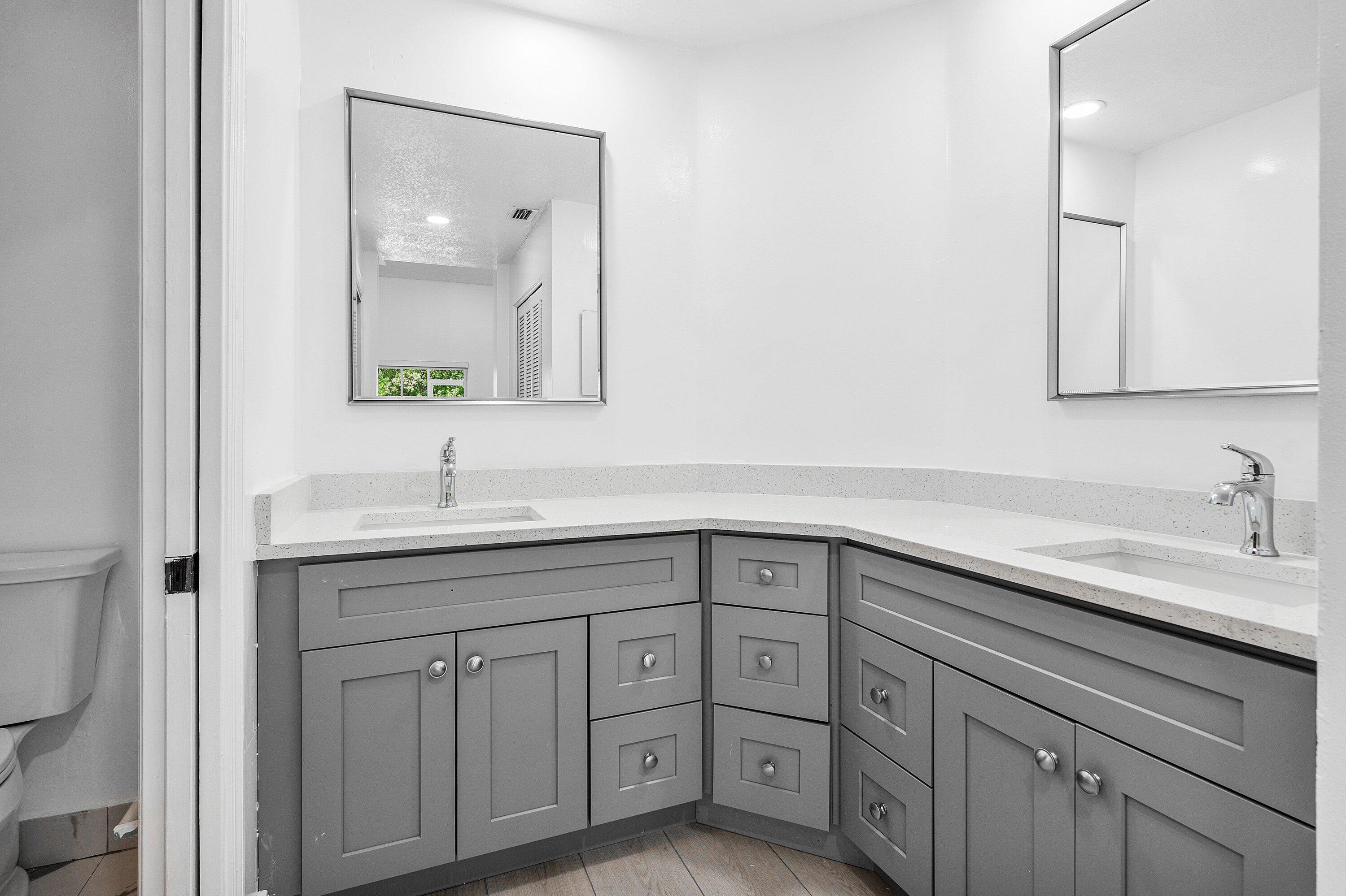 11163 180th Court South Boca Raton, FL 33498 - Photo 12 of 22 a bathroom with double sink and a mirror