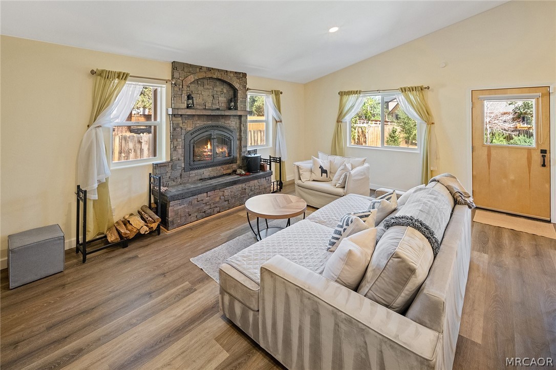 435 Wagon Wheel Road Big Bear City, CA 92314 - Photo 14 of 50 a living room with furniture a fireplace and a wooden floor